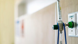 AdobeStock 326718924 edited 300x169 - oxygen flow regulator with tube scale for patients respirator or medical installed in the wall in room at hospital with copy space