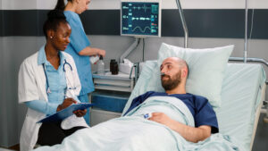 AdobeStock 446389060 300x169 - Afro american doctor discussing with sick man writing medical treatment